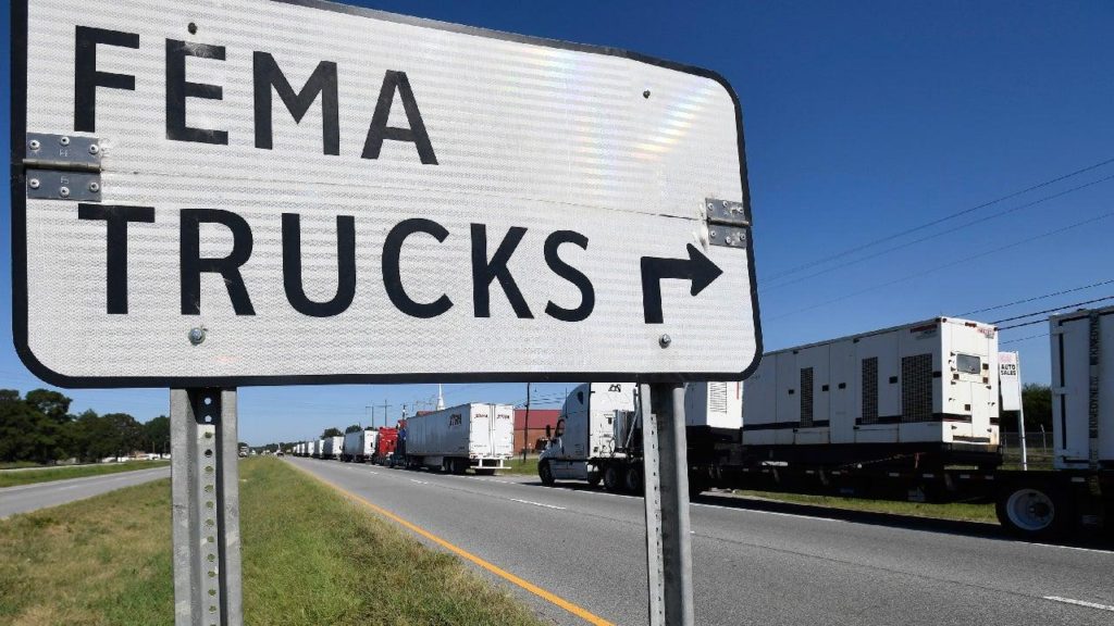 Line of FEMA trucks backed up on the road.