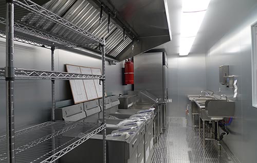Shipping container kitchen with shelves